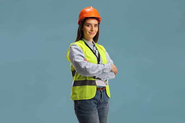 istock Young female site engineer with a safety vest and hardhat 1387071431
