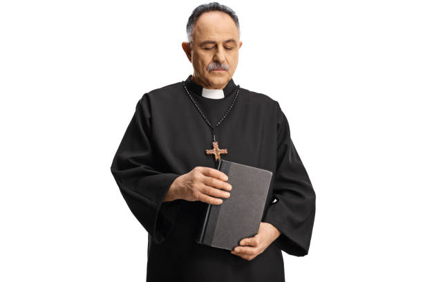 istock Mature priest holding a bible and looking down 1387071435
