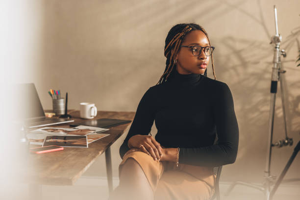 istock Young photographer looking away thoughtfully 1387073397