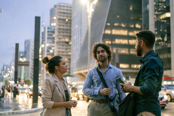 Coworkers talking outdoors in the city