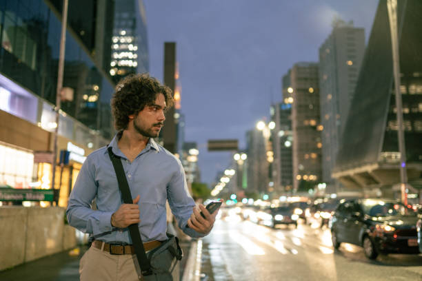 istock University student hailing taxi by app 1387073899