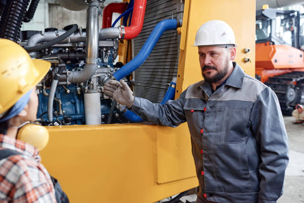 istock Confident foreman in workwear consulting young female subordinate 1387074013