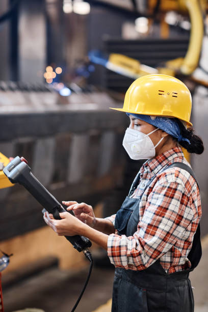 istock Side view of contemporary technician of factory using switch device 1387074622