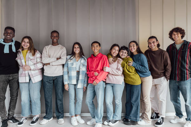Happy multiracial group of teenagers having fun inside university - Young people lifestyle concept stock photo