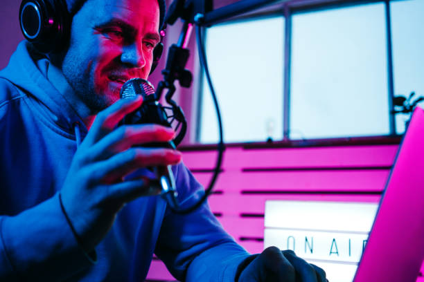 istock Cheerful streamer  broadcasting his audio show 1387076227