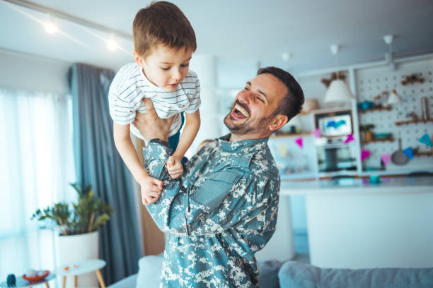 istock Happy soldier play with his son. 1387076323