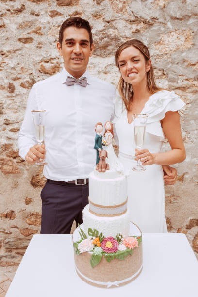 istock Loving beautiful couple at wedding with cake 1387078215