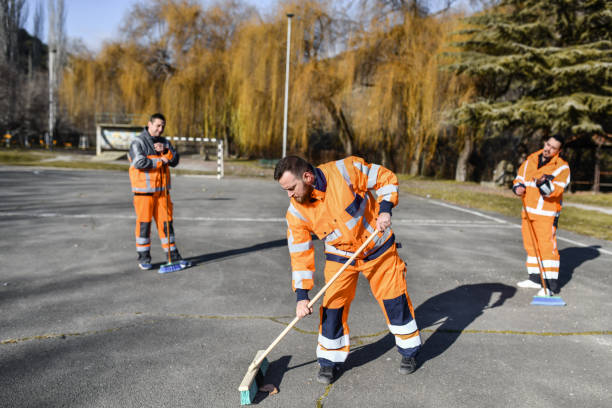 Modern Sanitation Workers Cleaning Outdoor Miniature Soccer Field And Playground Modern Sanitation Workers Cleaning Outdoor Miniature Soccer Field And Playground street sweeper stock pictures, royalty-free photos & images