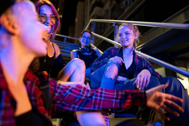 istock Young, smiling women talking on the stairs 1387080418