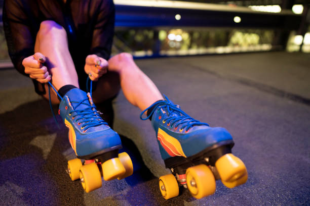 istock Unrecognized woman tying up her roller skates on the ground 1387080564