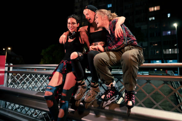 istock Urban female roller skaters laughing together 1387080569