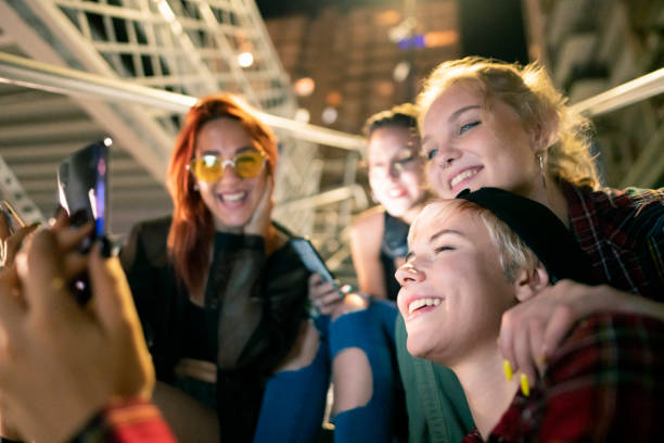 istock Young smiling women using smartphone 1387080602