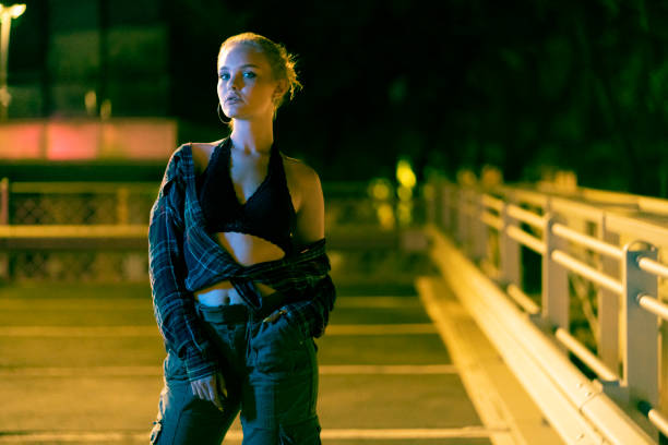 istock Young woman standing in the public parking alone 1387081694