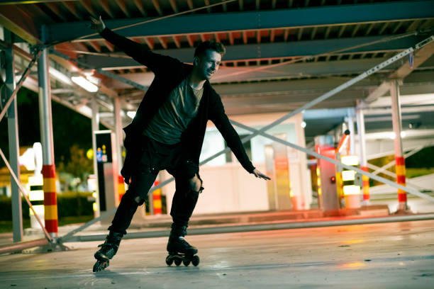 istock Young man enjoying inline skating in a public garage 1387081730