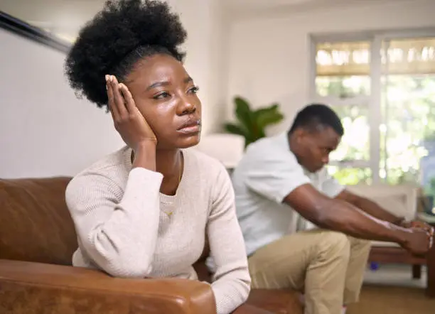 Photo of Shot of a young couple in an argument at home