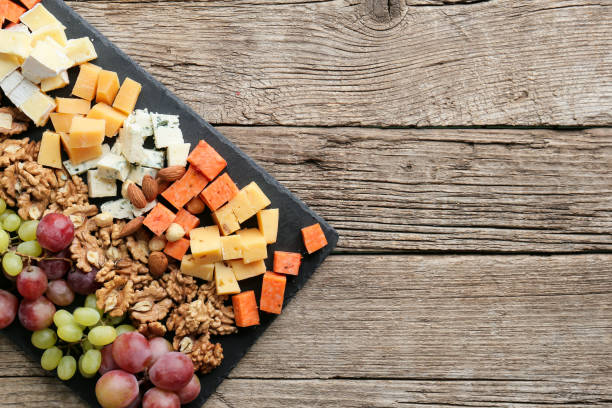 istock Cheese plate with variety of appetizers on table 1387083459