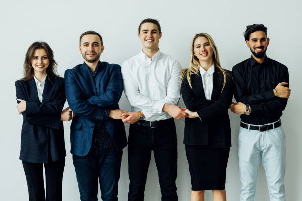 istock Group of business workers standing together shakinghands at the office 1387083697