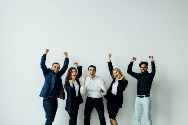 istock Cheerful active multiracial colleagues dancing enjoy corporate party or celebrating successful deal success at work common project feels happy have fun in office modern room during workday. 1387083835