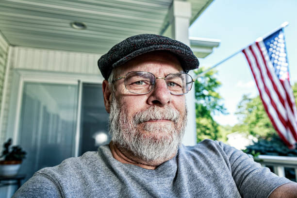 istock Casual Senior Man Sitting Outside Home 1387083914