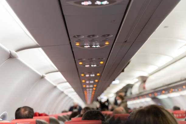 istock Blurred heads of people sitting on airplane 1387084006