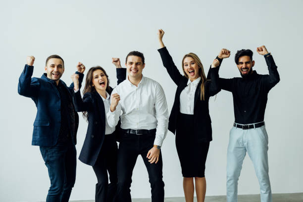 istock Cheerful active multiracial colleagues dancing enjoy corporate party or celebrating successful deal success at work common project feels happy have fun in office modern room during workday. 1387084668