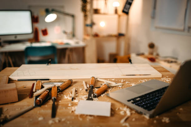 istock Laptop with hand tools and wood on workbench in studio 1387085264