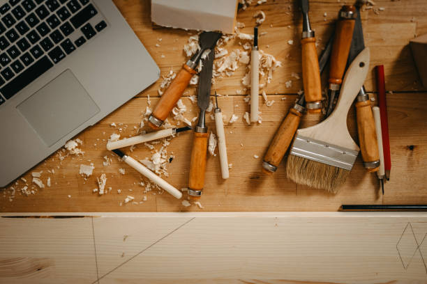 istock Laptop with wood and various hand tools on workbench in art studio 1387085303