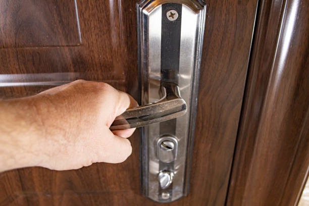 istock Close-up of a man hand on the front door handle. 1387085522