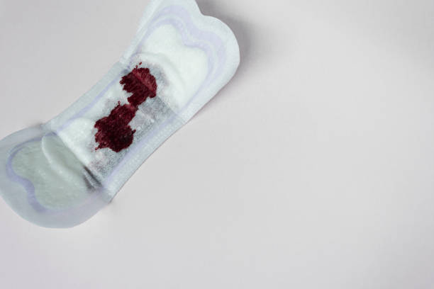 Menstrual blood on a sanitary pad. Flat lay. Copy space. stock photo