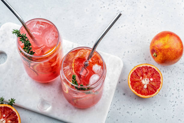 istock Blood Orange Margarita cocktail with ice and thyme 1387086531