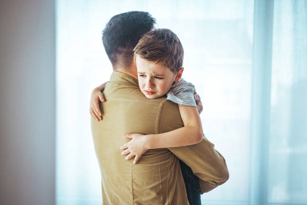 istock Portrait of a crying child on hands a father. 1387086775
