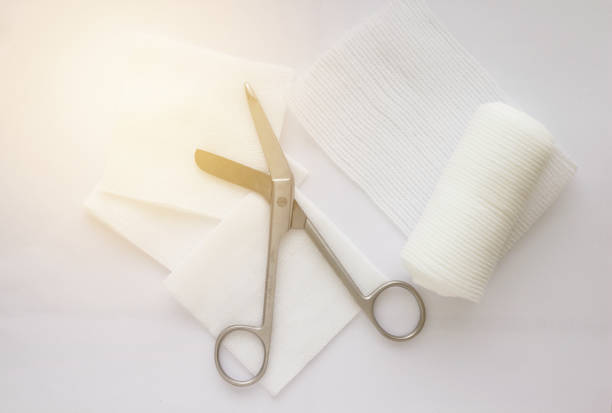 istock Gauzes, scissors and roll gauze on white background,closed up 1387087672