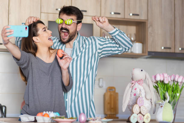 istock Happy couple taking a selfie celebrating Easter at home 1387090711