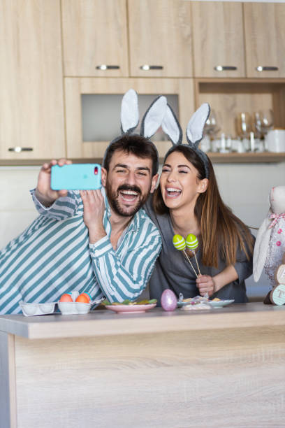 istock Beautiful young couple smiling taking a picture celebrating Easter 1387090942