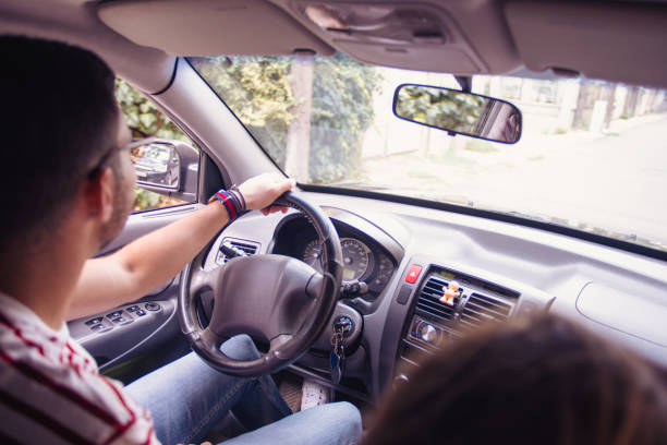 istock Handsome young Man parking the car 1387091140