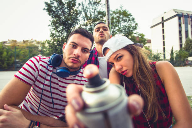 Young and careless people are being serious and spending time together at urban place