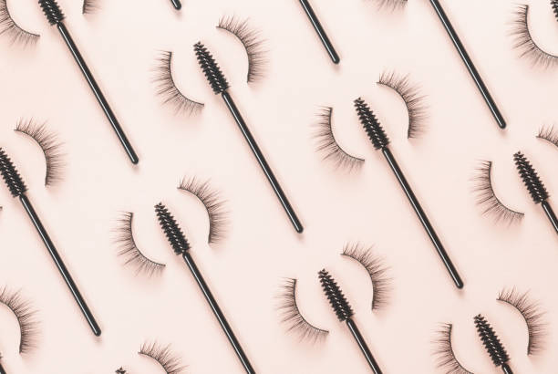 istock Overhead eyelashes and brushes on an orange background. 1387091668