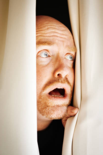 istock Man parts his curtains and gets a terrible shock, making him gape 1387094902