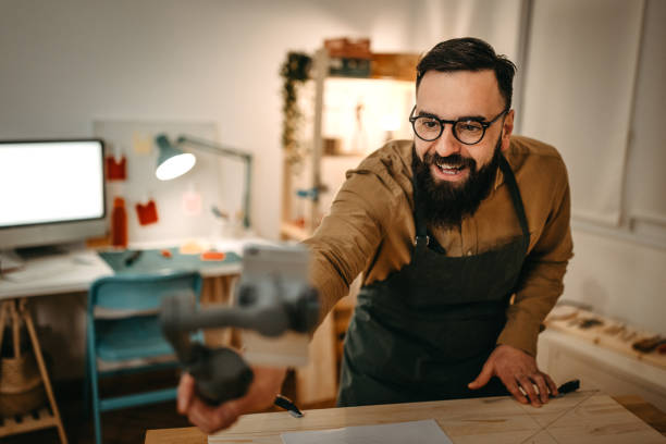 istock Bearded artist guiding while vlogging over smart phone in studio 1387095215