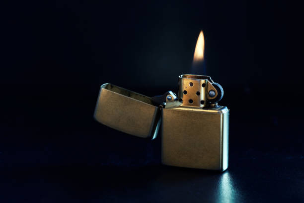istock Old Metal Flint-wheel Lighter on dark background 1387097851