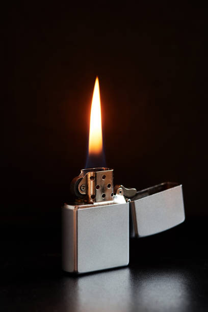 istock Old Metal Flint-wheel Lighter on dark background 1387097866