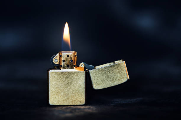 istock Old Metal Flint-wheel Lighter on dark background 1387097868