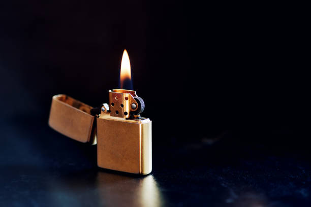 istock Old Metal Flint-wheel Lighter on dark background 1387097874