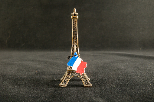 Eiffel Tower toy miniature on black background