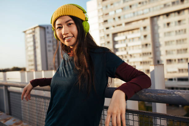 istock Smiling girl with headphones 1387103153
