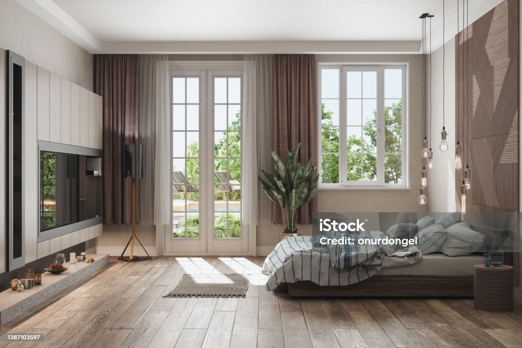 Side View Of Luxurious Bedroom With Messy Bed, TV Set And Garden View From The Window Side View Stock Photo