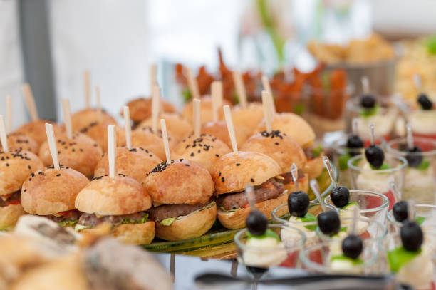 istock Birthday Table With Food. Snacks and Appetizer on the Table. Fish and Raw Meat with Vegetables. Burger with Meat. 1387103634