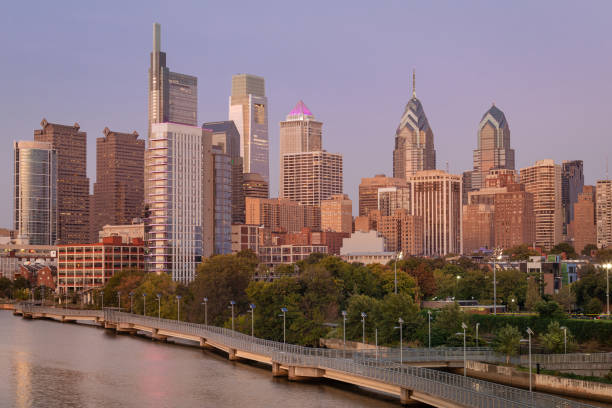 istock Philadelphia Downtown skyline with the Schuylkill river. Beautiful Sunset Light. Schuylkill River Trail in Background. City skyline glows under the beautiful sunset light. Cityscape. PA, USA. 1387103878