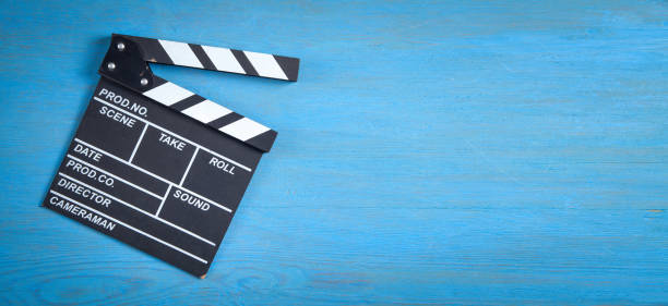 istock Movie clapper on the blue background. 1387105402