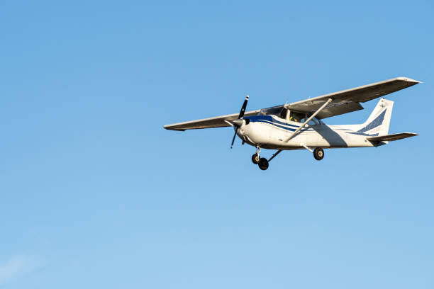 Small plane flying with sunset light in a clear sky before landing on Sabadell Airport. Small plane flying with sunset light in a clear sky before landing on Sabadell Airport. propeller airplane stock pictures, royalty-free photos & images